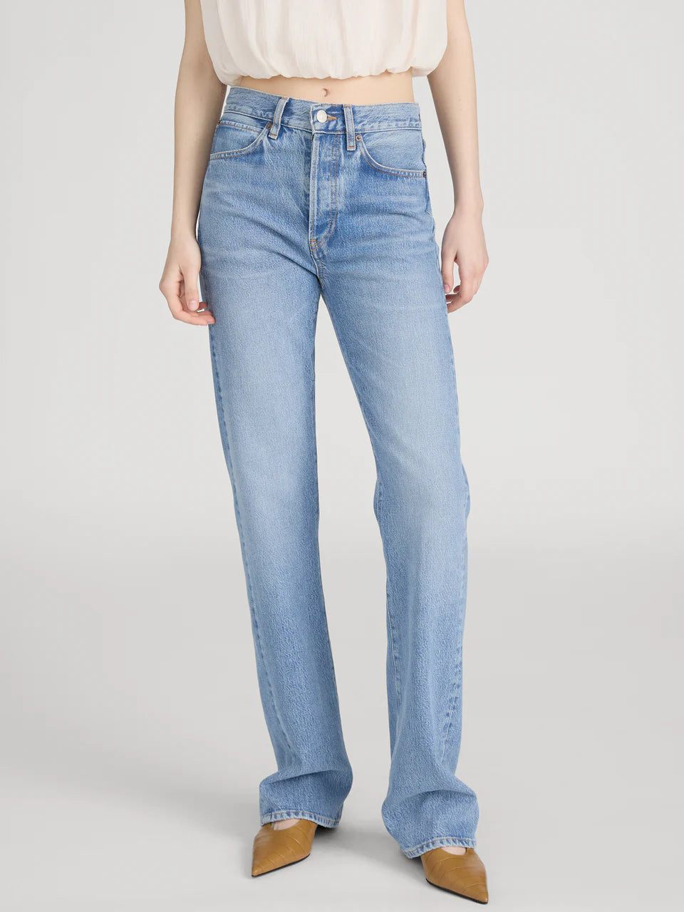 Light blue jeans worn by a person on a white background