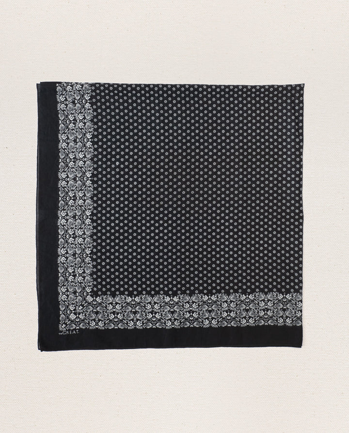 Black and white patterned fabric square on a light beige background