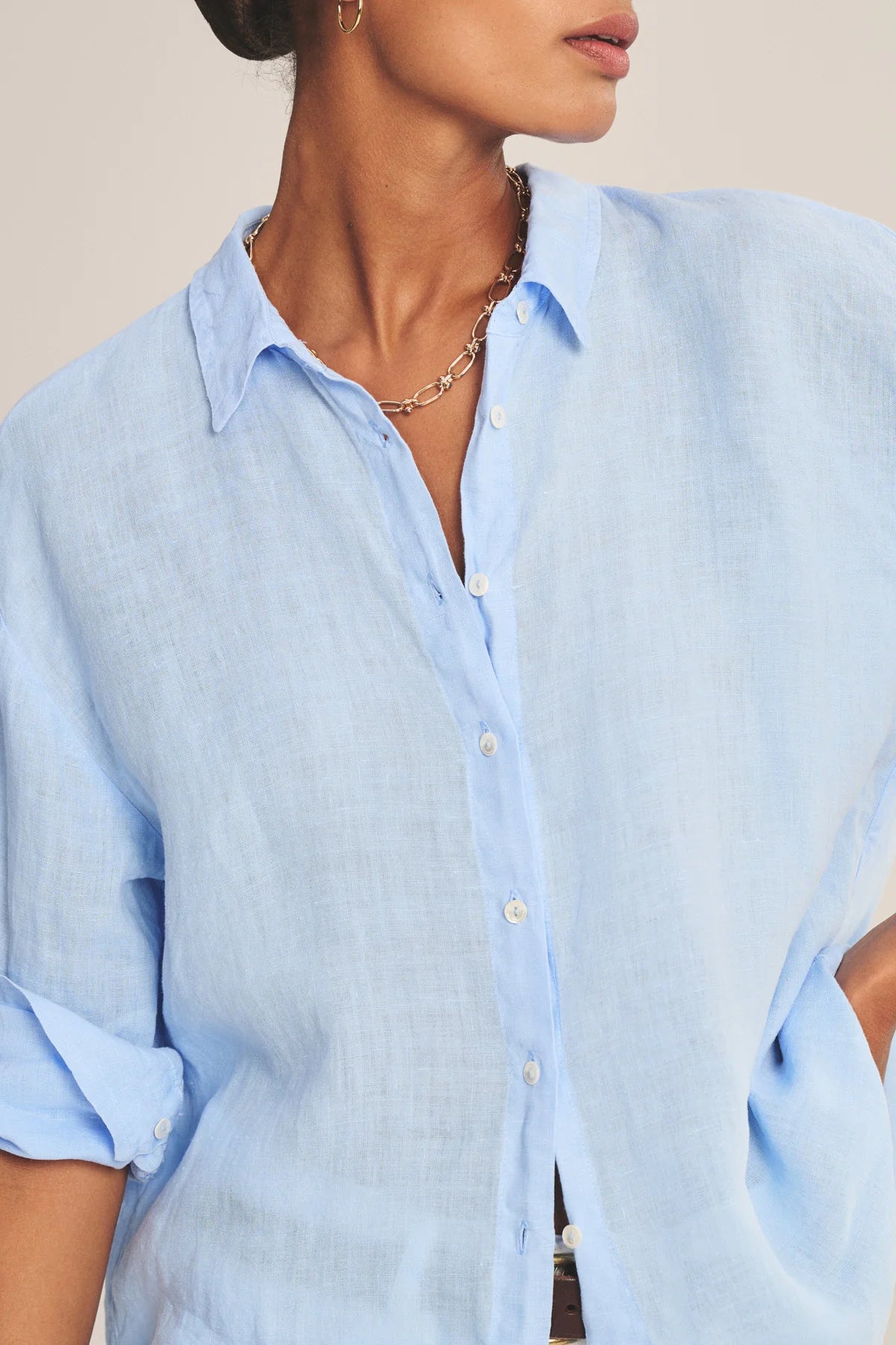 Light blue button-up shirt worn by a person with a neutral background