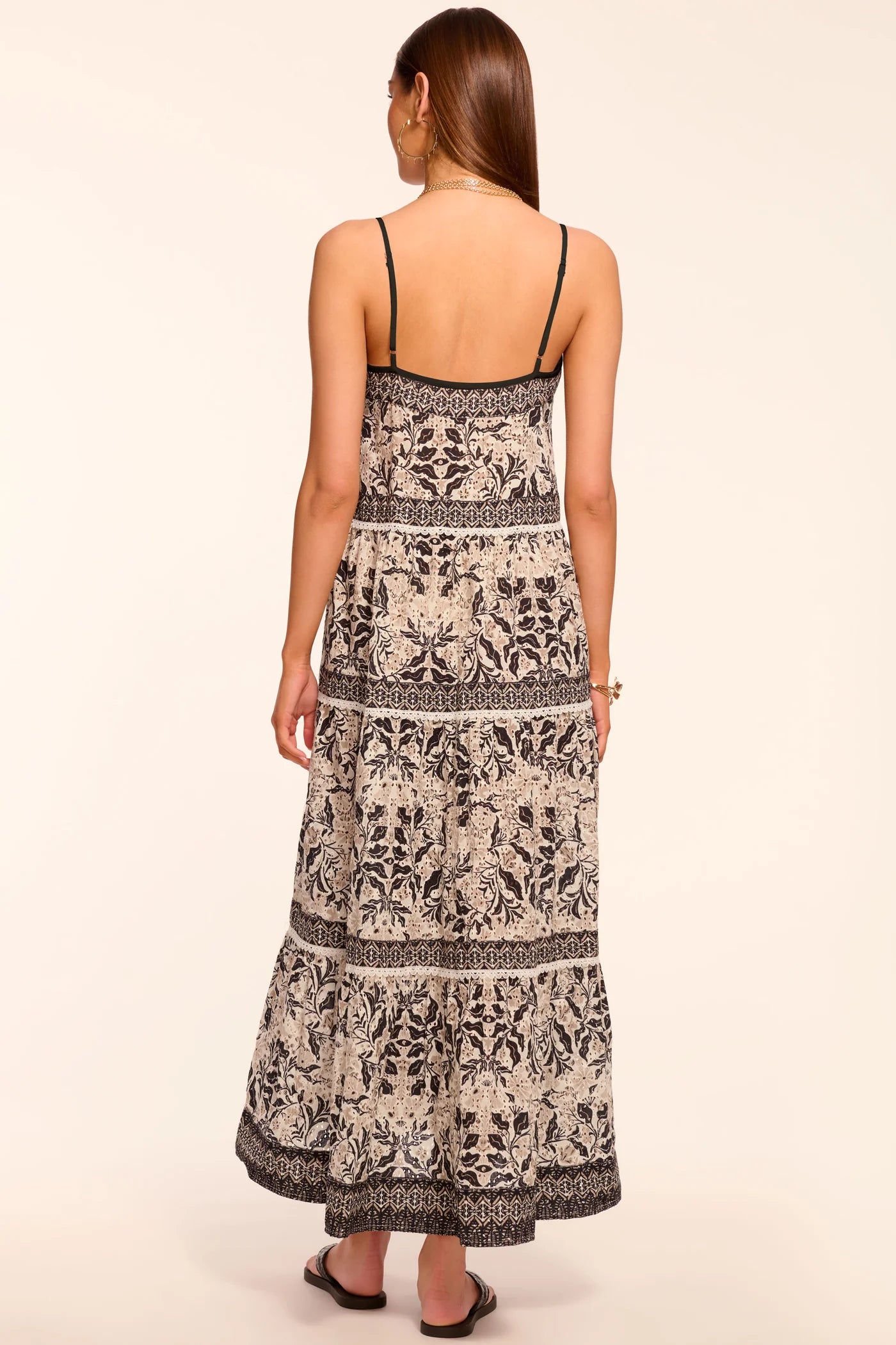 Woman wearing a patterned dress on a beige background