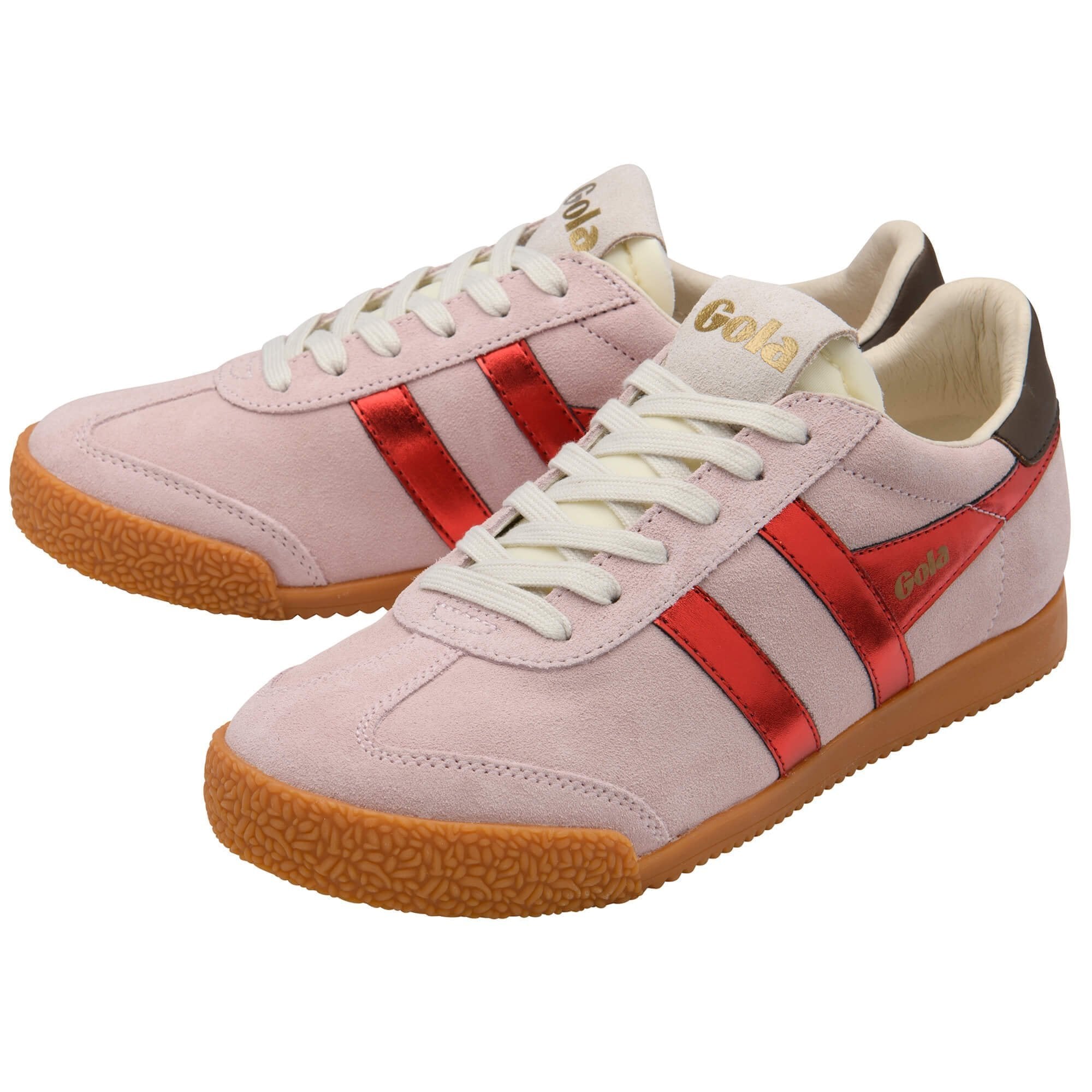 Pink sneakers with red stripes and brown soles on a white background