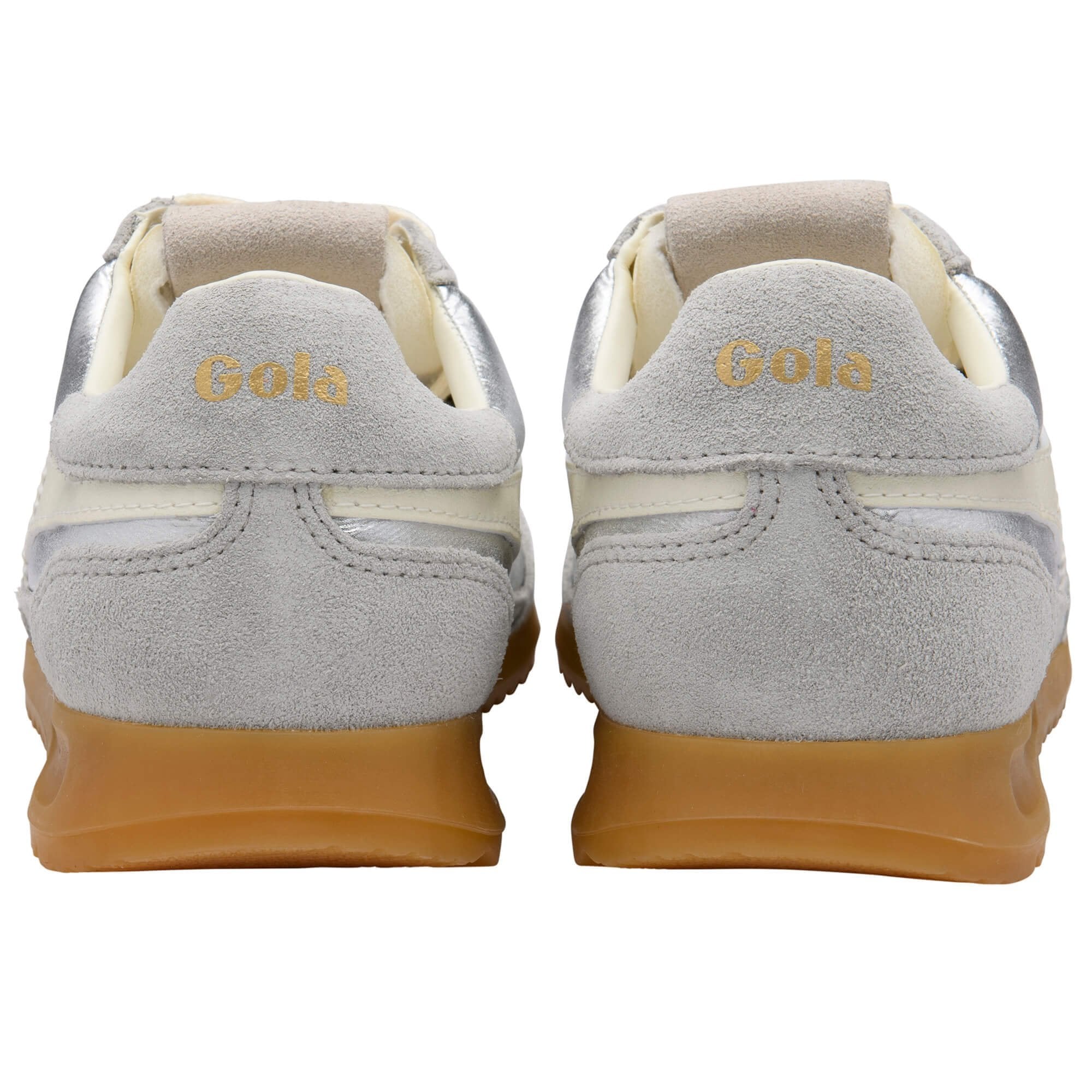 Pair of silver sneakers with white laces and brown soles on a white background