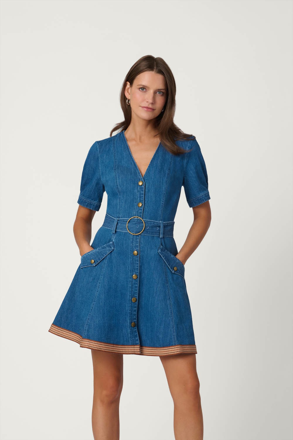 Woman wearing a blue denim dress on a white background