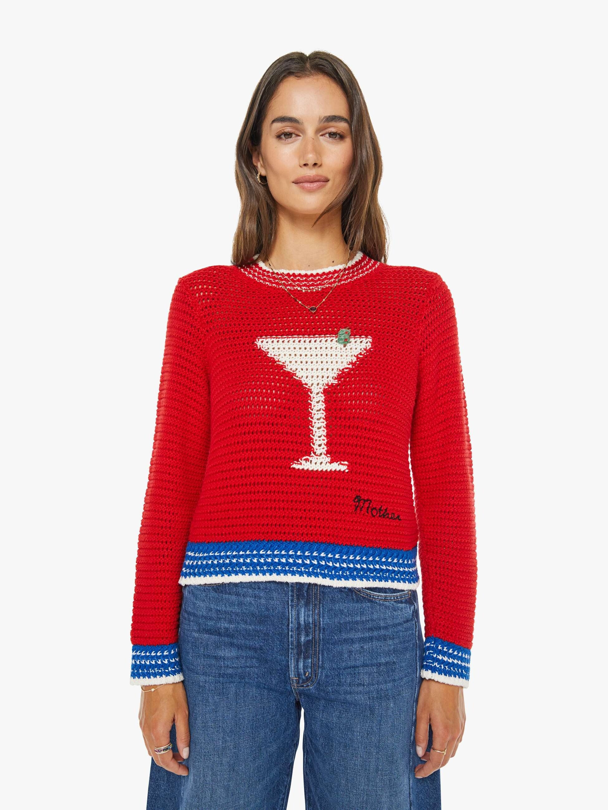 Person wearing a red sweater with a martini glass design on a white background