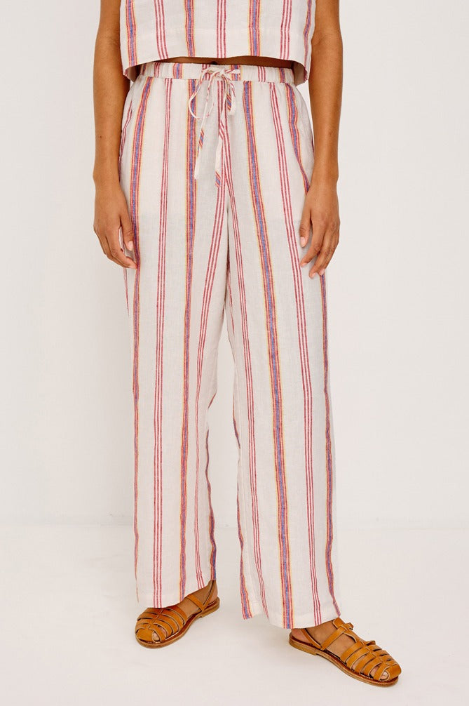 Person wearing red and white striped pants with a plain background