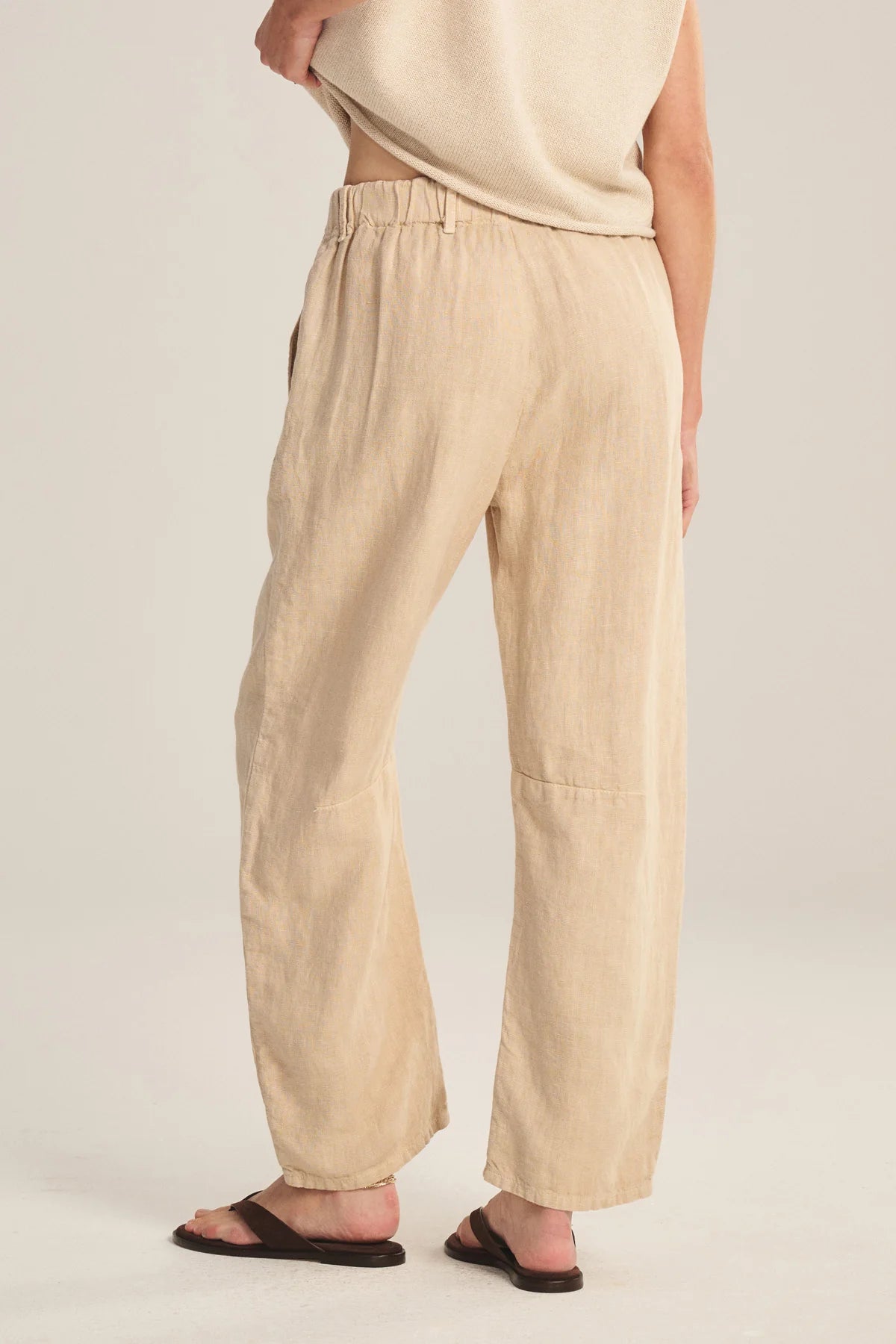 Beige pants worn by a person on a plain background