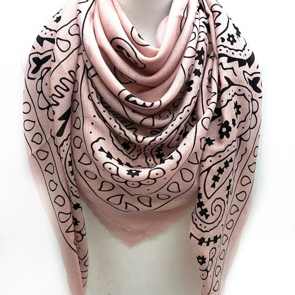 Pink scarf with black patterns on a white background