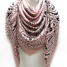 Pink scarf with black patterns on a white background