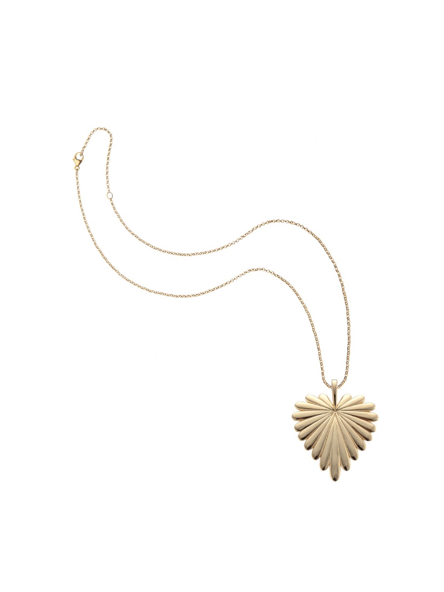 Gold necklace with a heart-shaped pendant on a white background