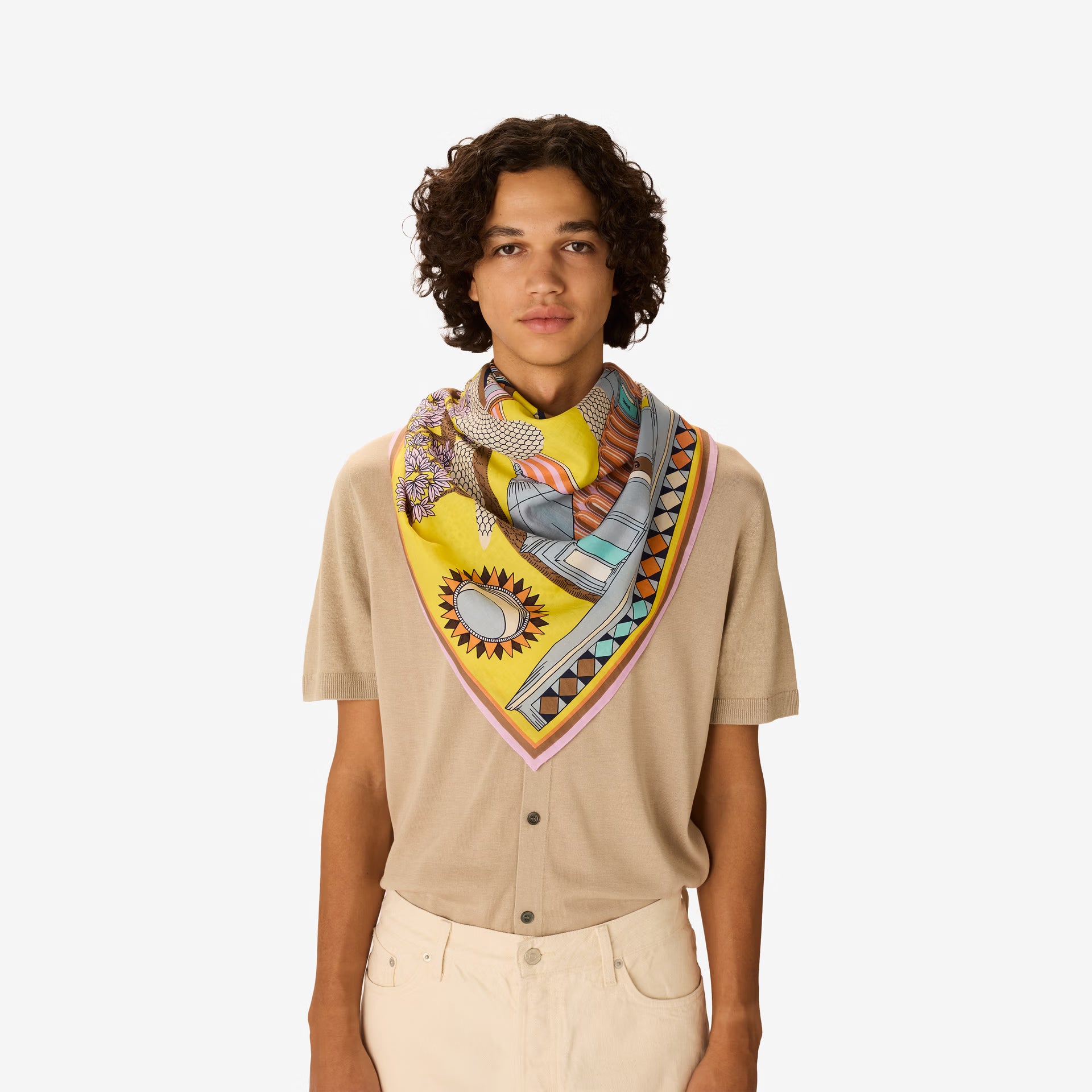 Person wearing a colorful scarf with a yellow center on a white background