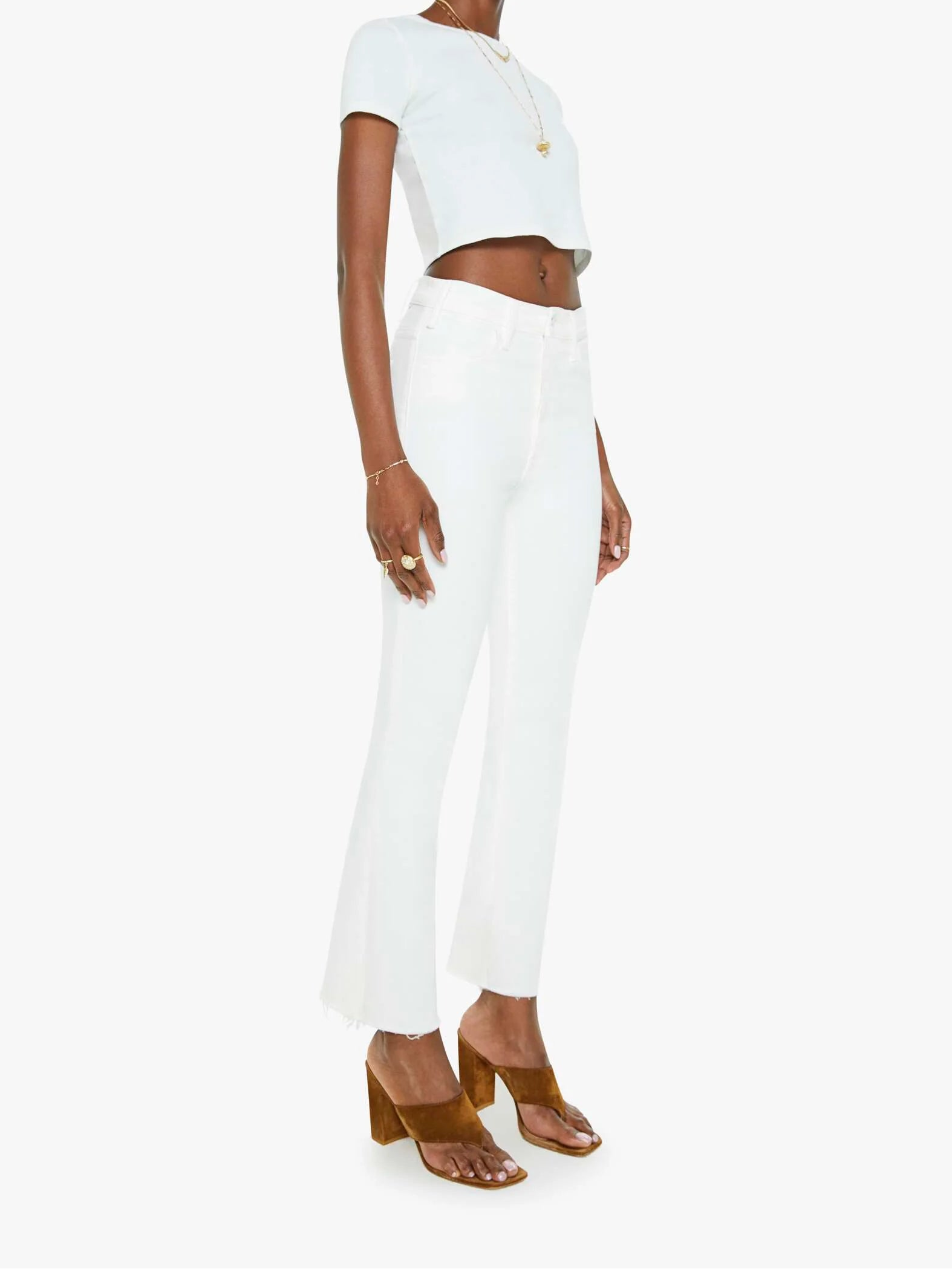 Woman wearing a white outfit with a plain background