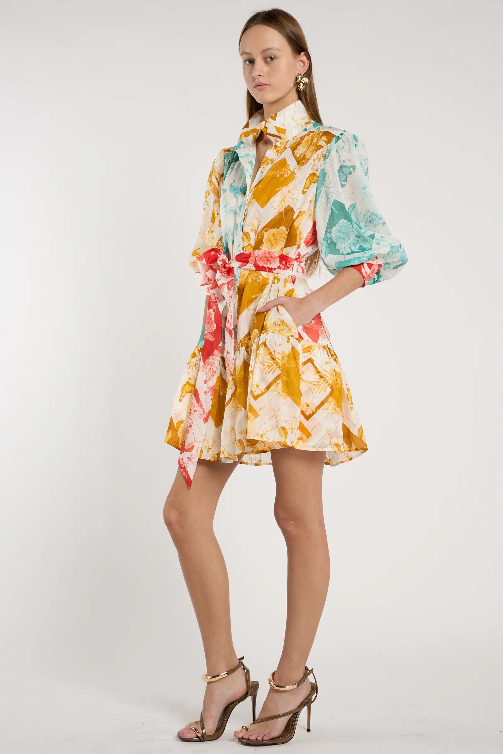 Woman wearing a colorful floral dress on a white background