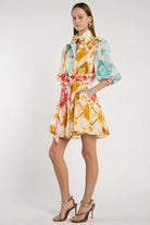 Woman wearing a colorful floral dress on a white background