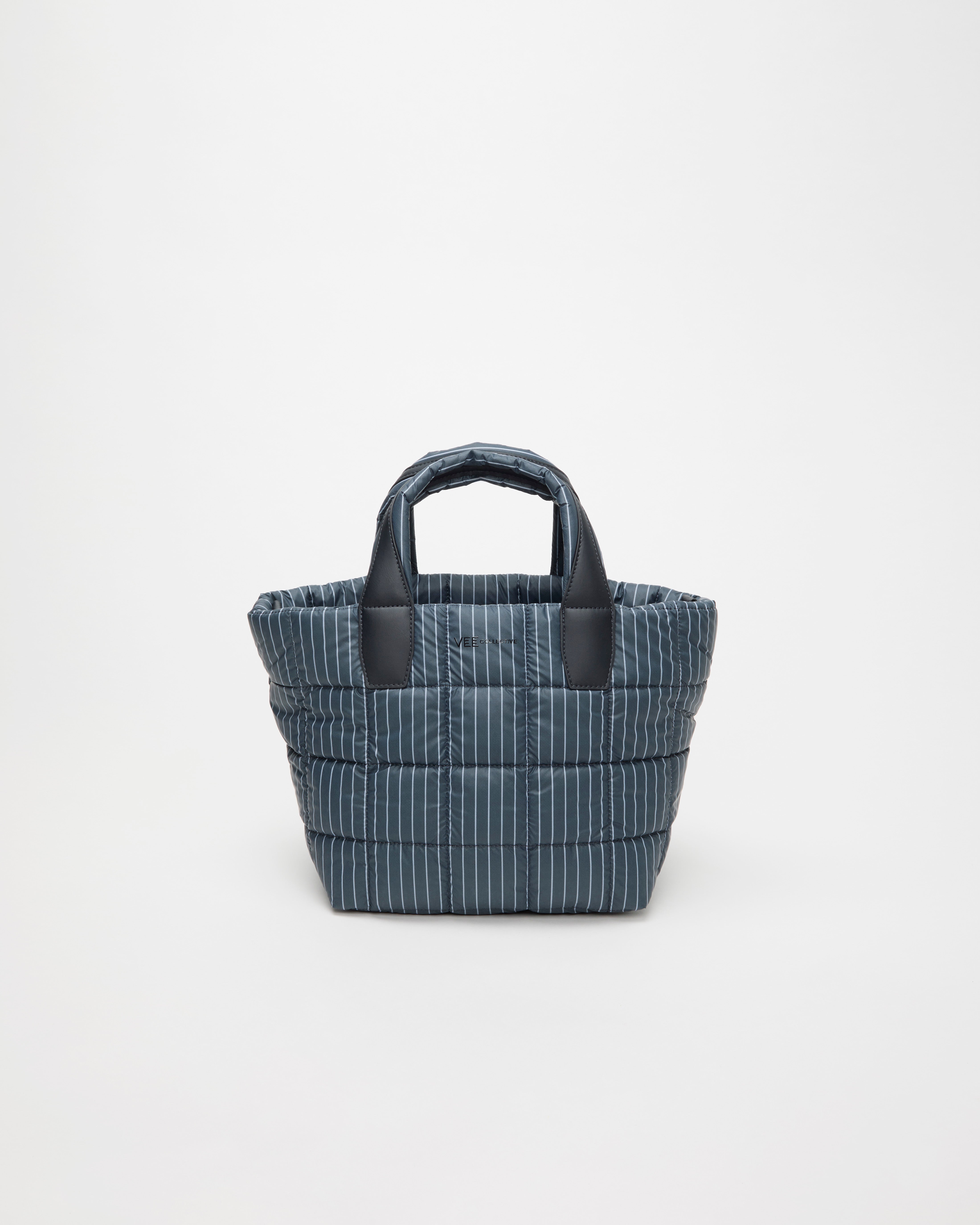 Blue striped fabric basket with black handles on a white background