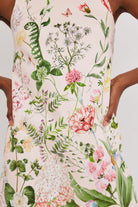 Floral dress with pink flowers and green leaves on a white background