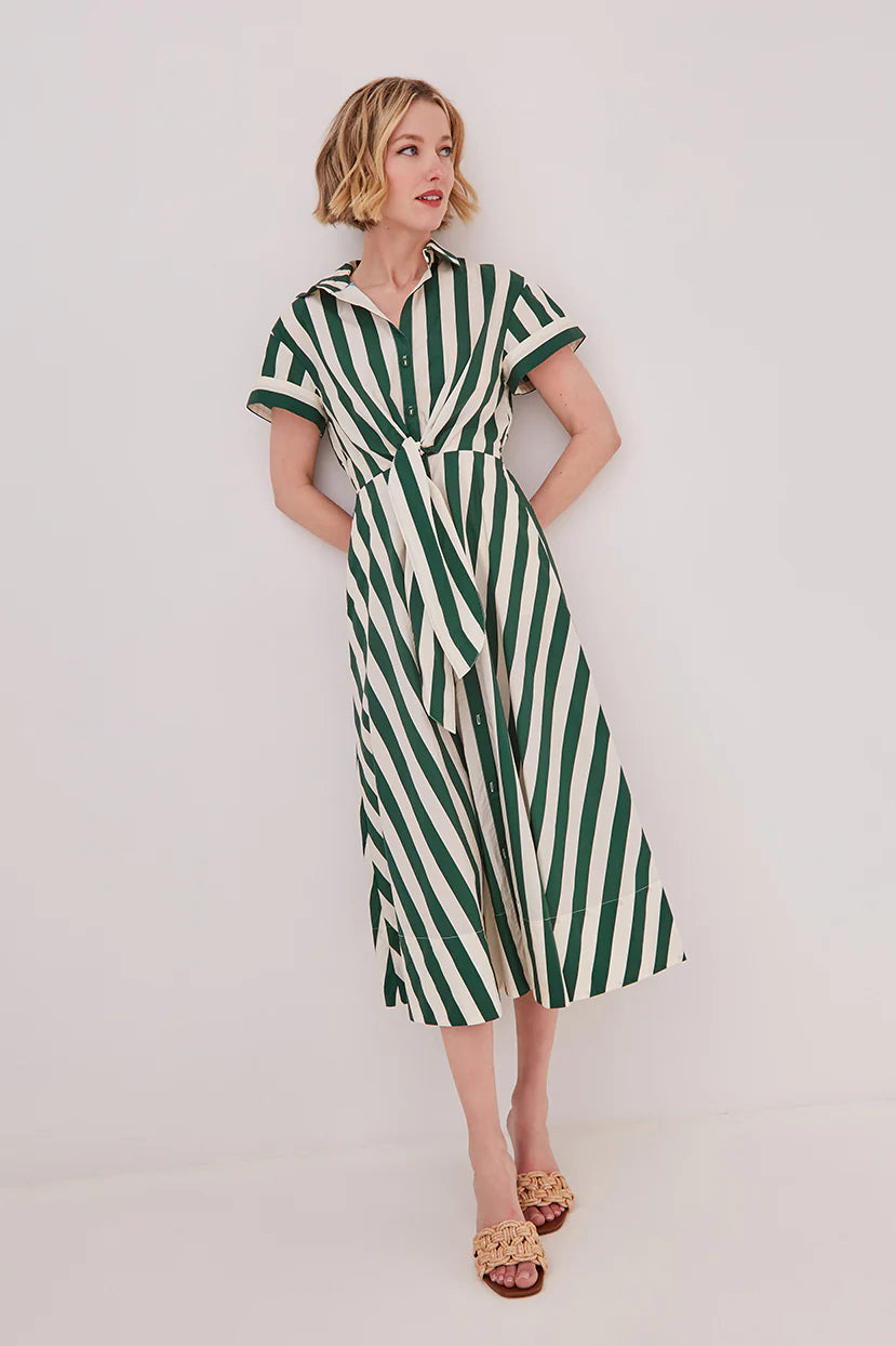 Woman wearing a green and white striped dress against a white background