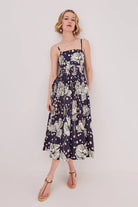 Woman wearing a floral dress on a plain background