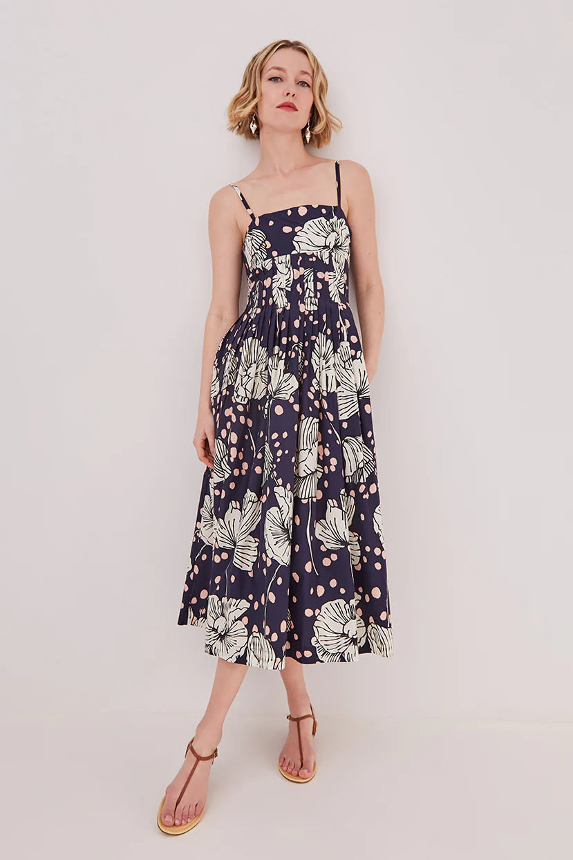 Woman wearing a floral dress on a plain background