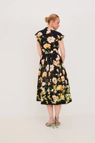 Woman wearing a floral dress on a white background