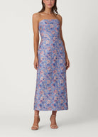 Woman wearing a strapless floral dress on a white background