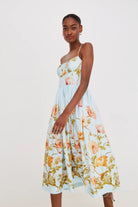 Woman wearing a floral dress on a plain background