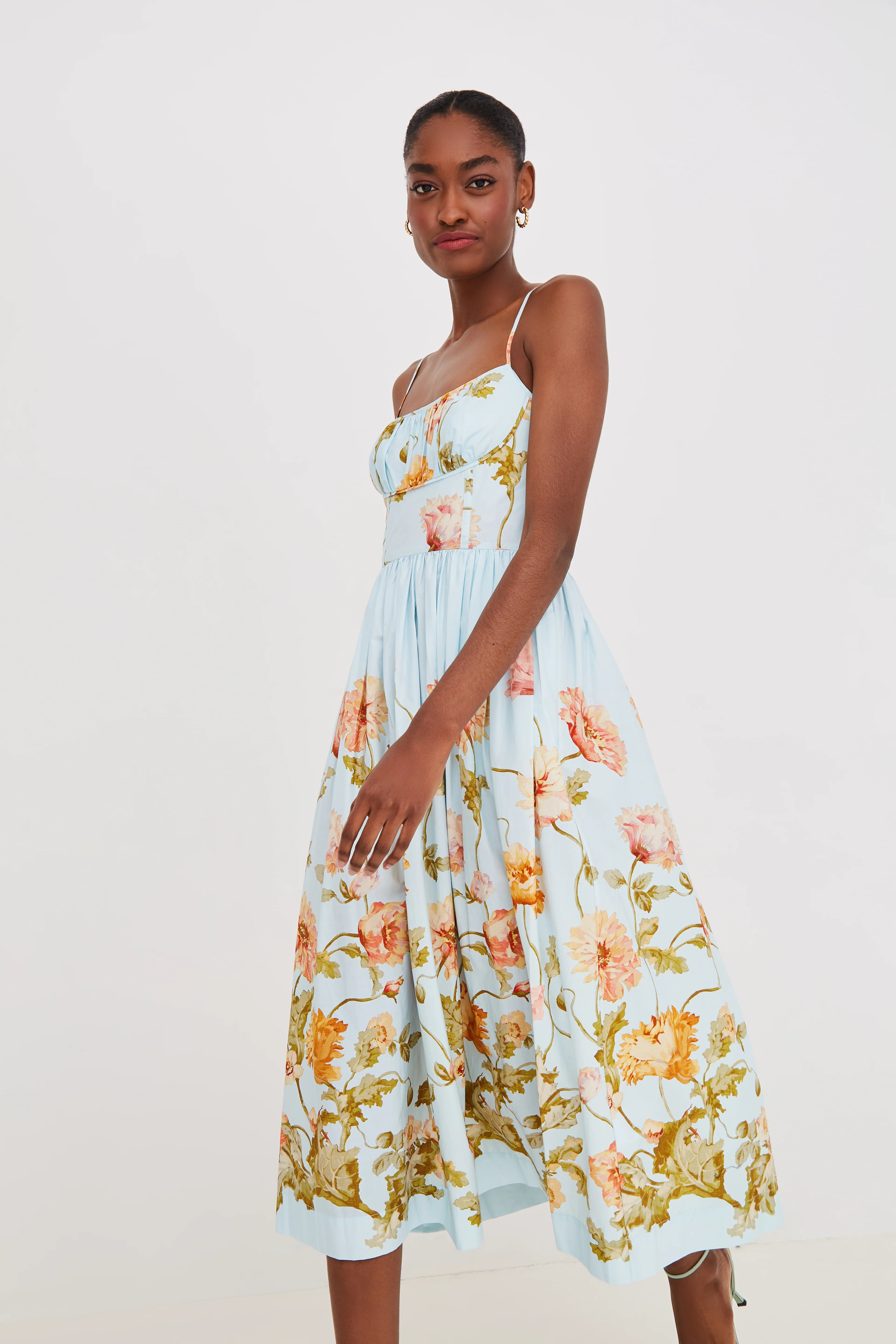 Woman wearing a floral dress on a plain background