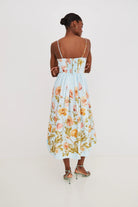 Woman wearing a floral dress on a plain background