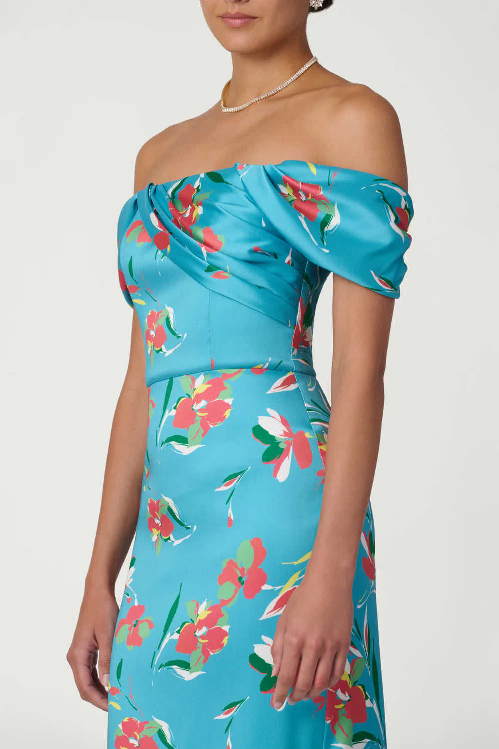 Woman wearing a blue floral strapless dress on a white background