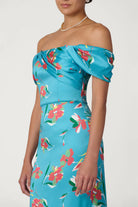 Woman wearing a blue floral strapless dress on a white background