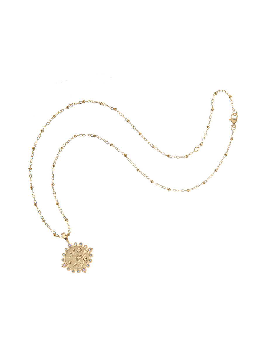 Gold necklace with a sunflower pendant on a white background