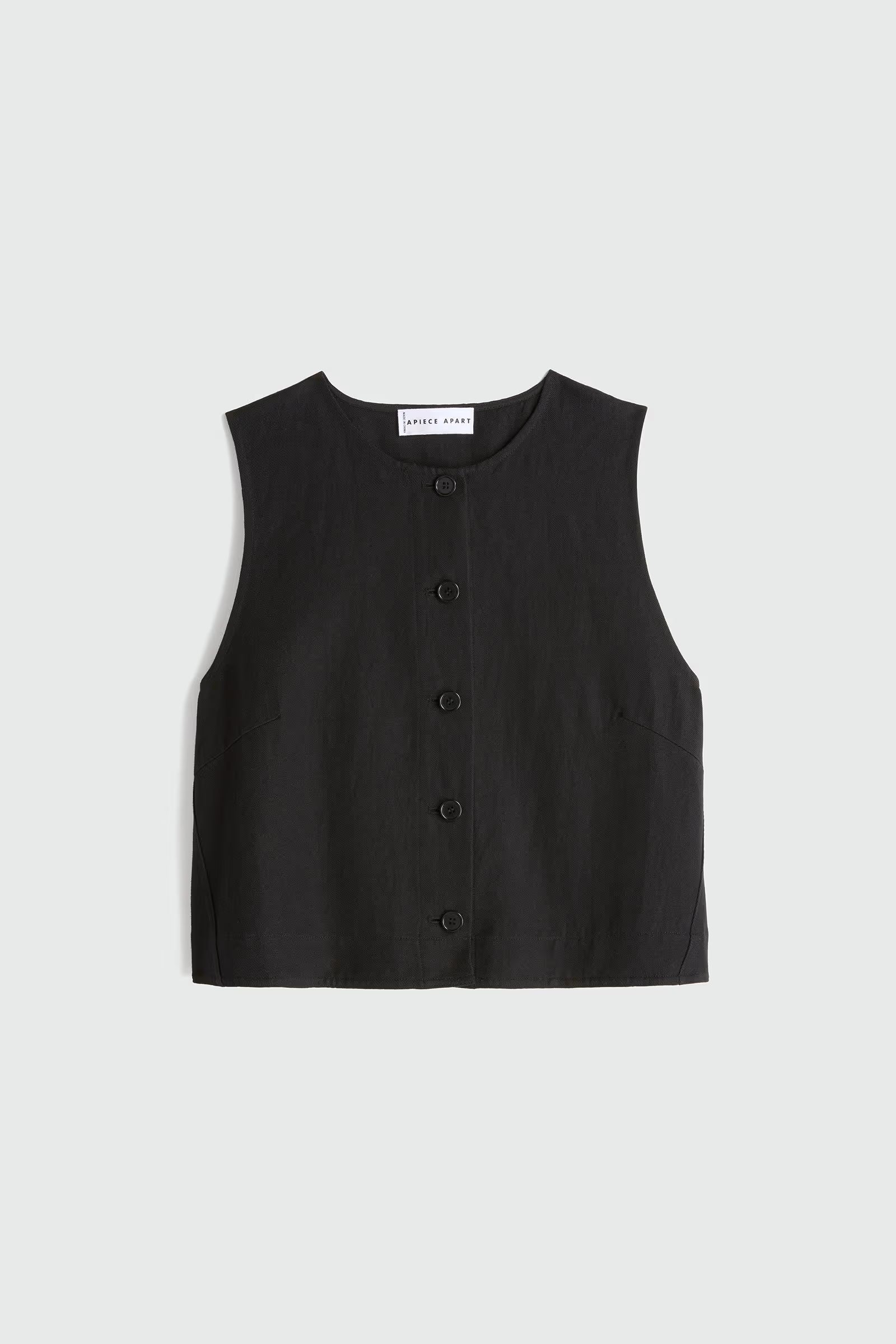 Black sleeveless button-up top on a light gray background