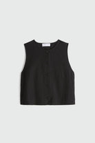 Black sleeveless button-up top on a light gray background