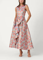 Woman wearing a floral dress with ruffled details on a white background
