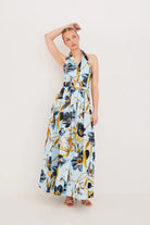 Woman wearing a floral dress on a plain background