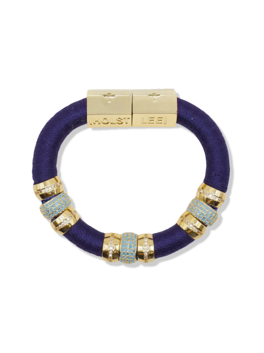 Purple bracelet with gold and silver beads on a white background