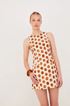Woman wearing a polka dot dress on a white background