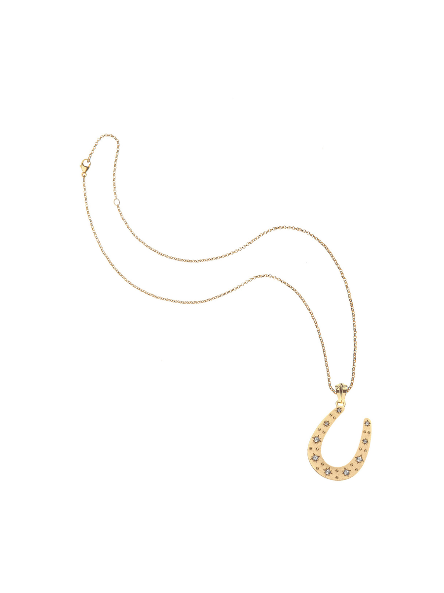 Gold necklace with a horseshoe pendant on a white background