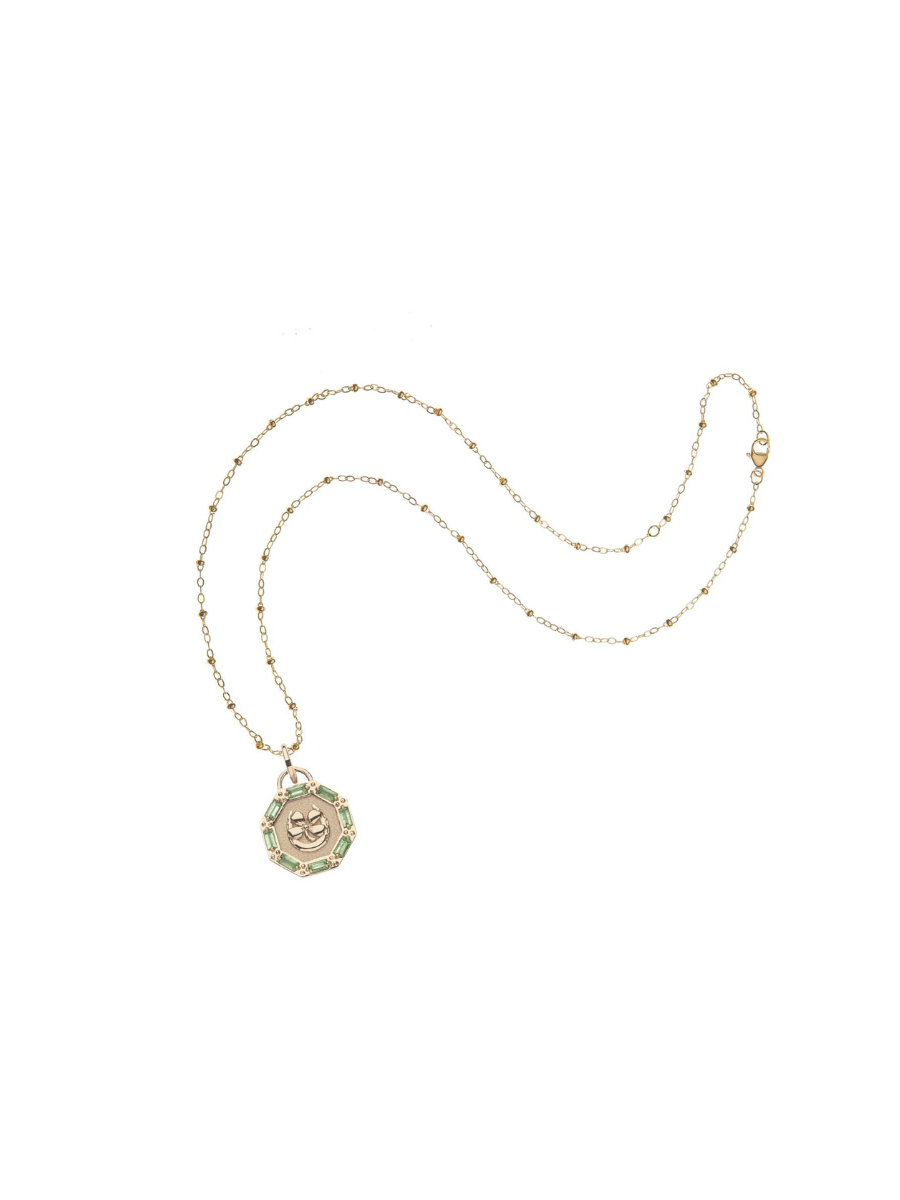 Gold necklace with a pendant on a white background