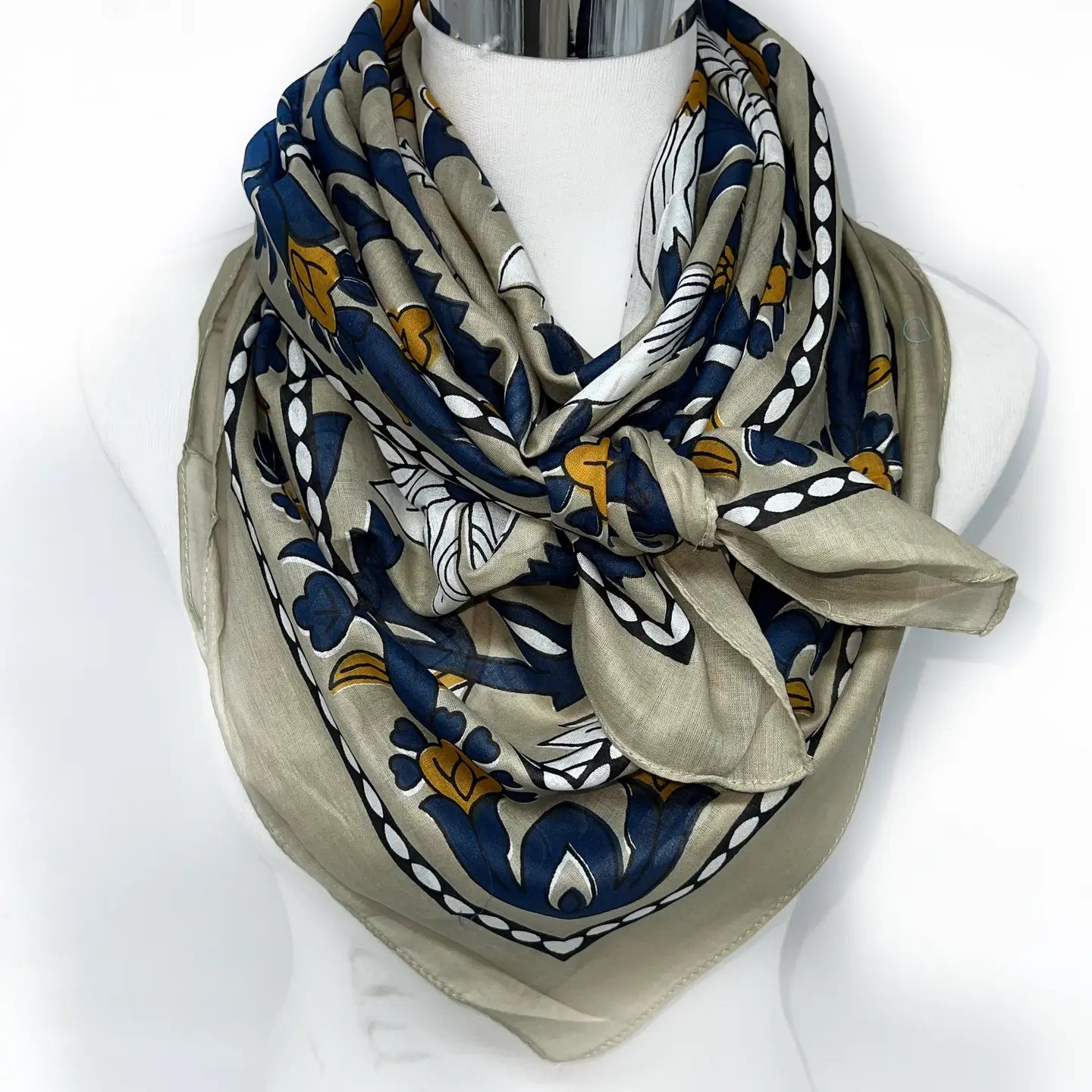 Patterned scarf on a mannequin with a white background