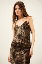 Woman wearing a patterned dress against a plain background