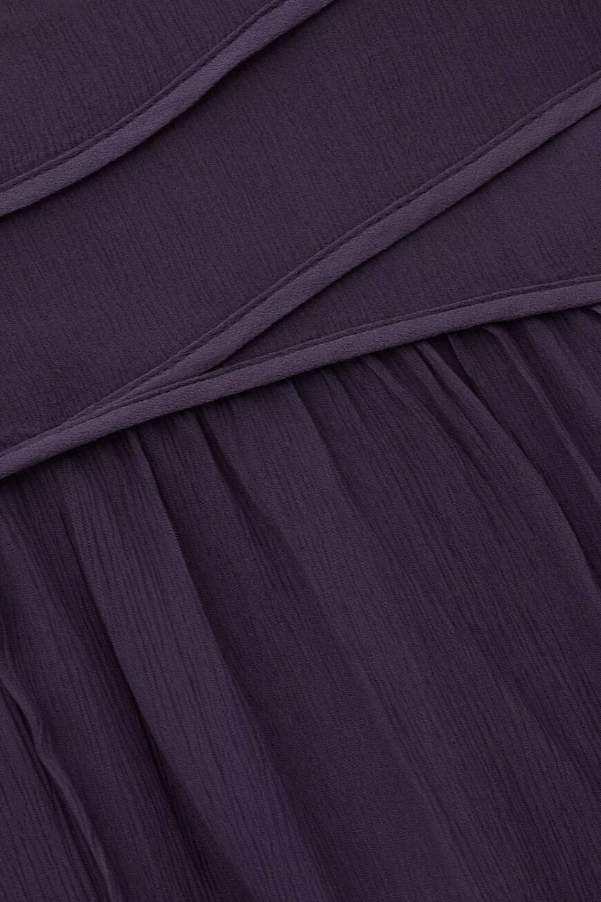 Close-up of a dark purple fabric with folds