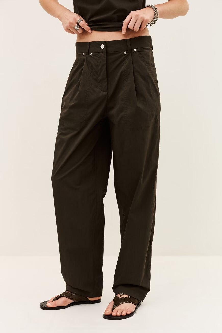 Person wearing black pants on a white background