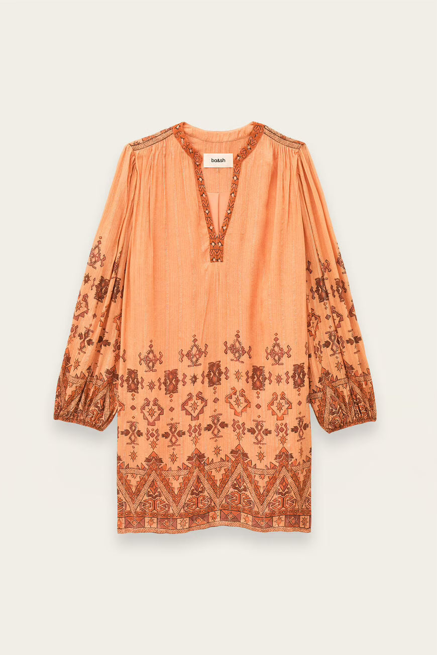 Peach-colored dress with intricate patterns on a light beige background