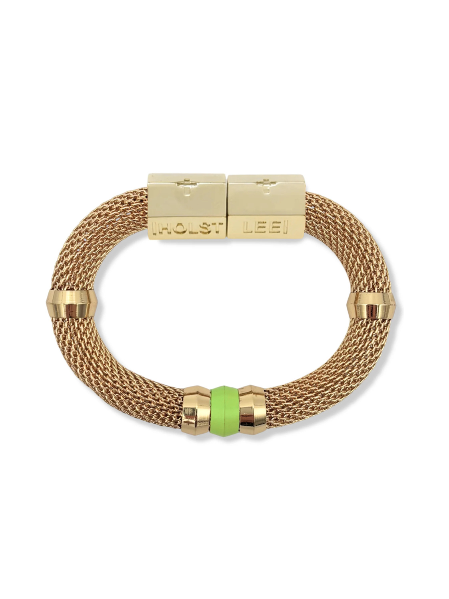 Gold bracelet with green bead on a white background