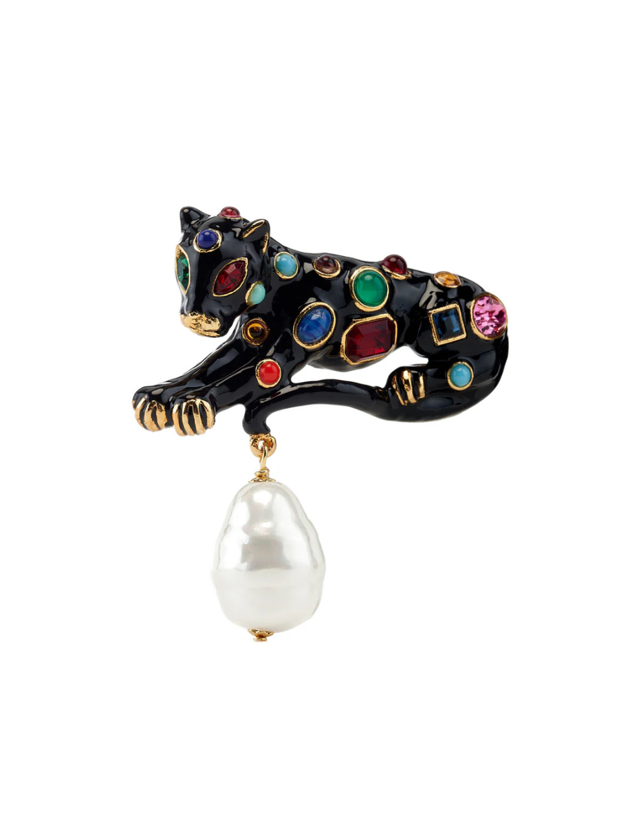 Decorative brooch shaped like a panther with gemstones and a pearl on a white background