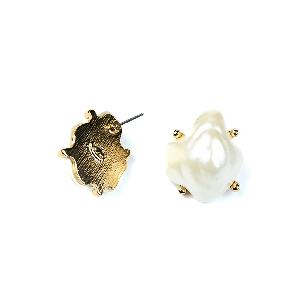 Gold and pearl earring on a white background
