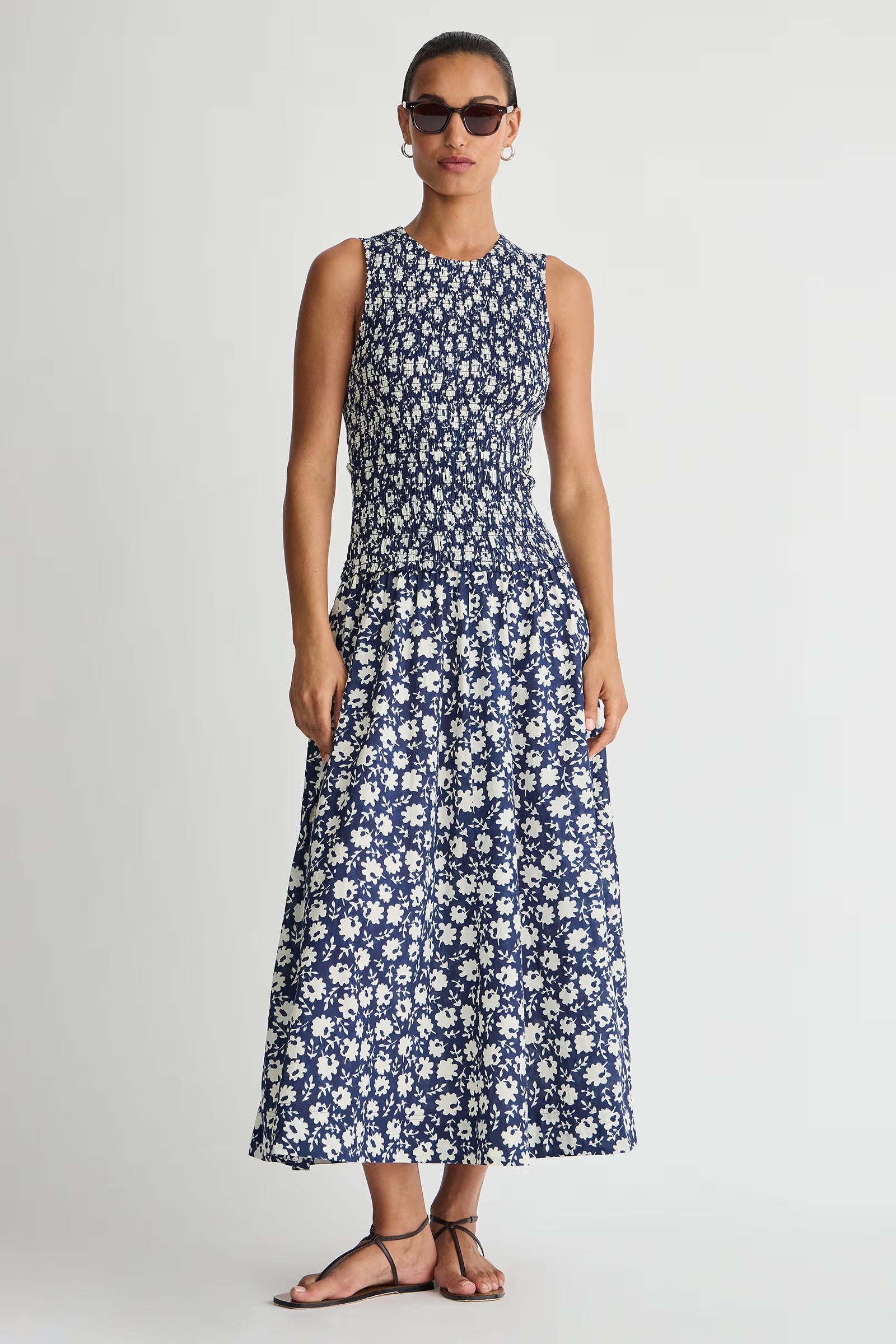 Woman wearing a blue floral dress on a white background