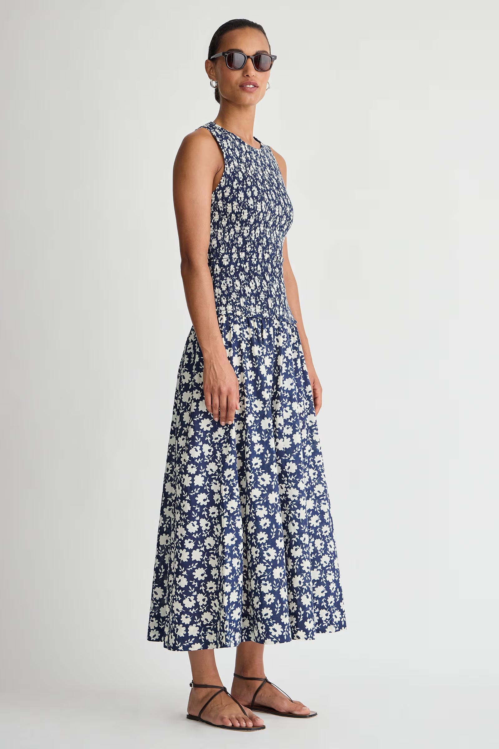 Woman wearing a blue floral dress on a white background