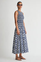 Woman wearing a blue floral dress on a white background