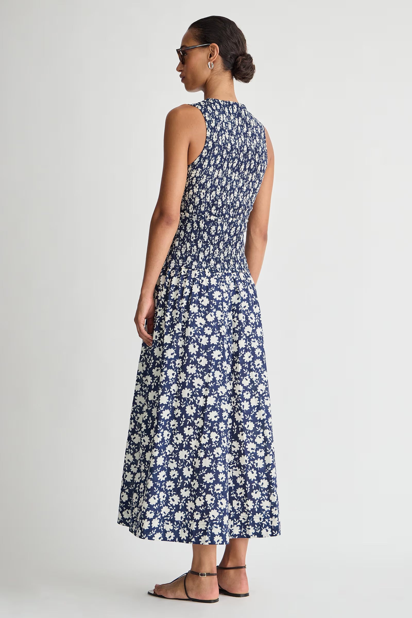 Woman wearing a blue floral dress on a white background